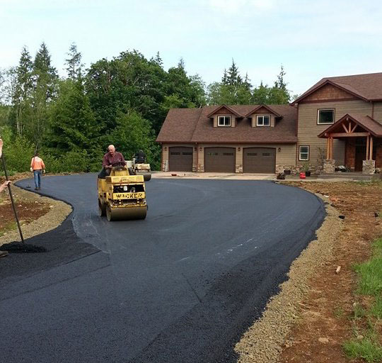 Mike George Paving & seal coating paving a residential driveway