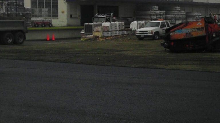 Multiple vehicles next to warehouse