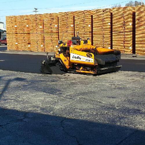 Paver beginning to pave asphalt on a lot