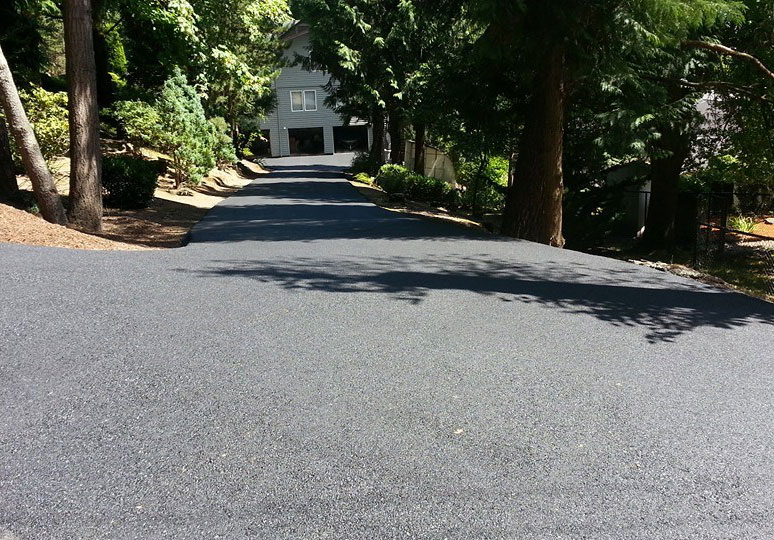 A Long residential driveway with new asphalt