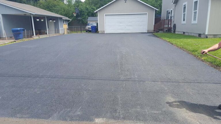 Nicely paved asphalt driveway with sand rubbed on it