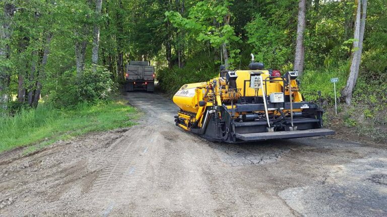 Preparations being done for new asphalt road to be paved on a forest trail