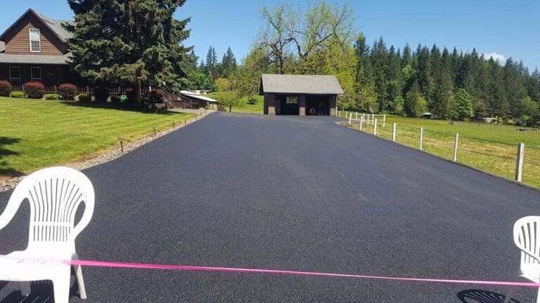 Freshly paved driveway with chairs blocking the entrance