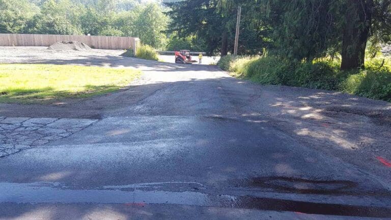 Asphalt dumping on a dirt road