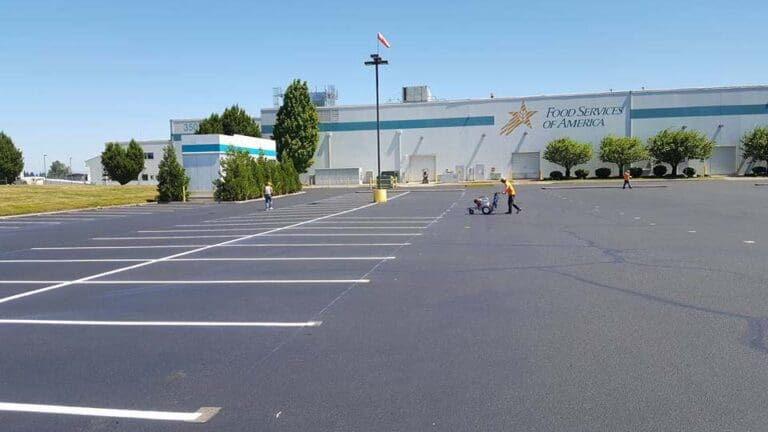Pavers painting a parking lot of a Food Services of America